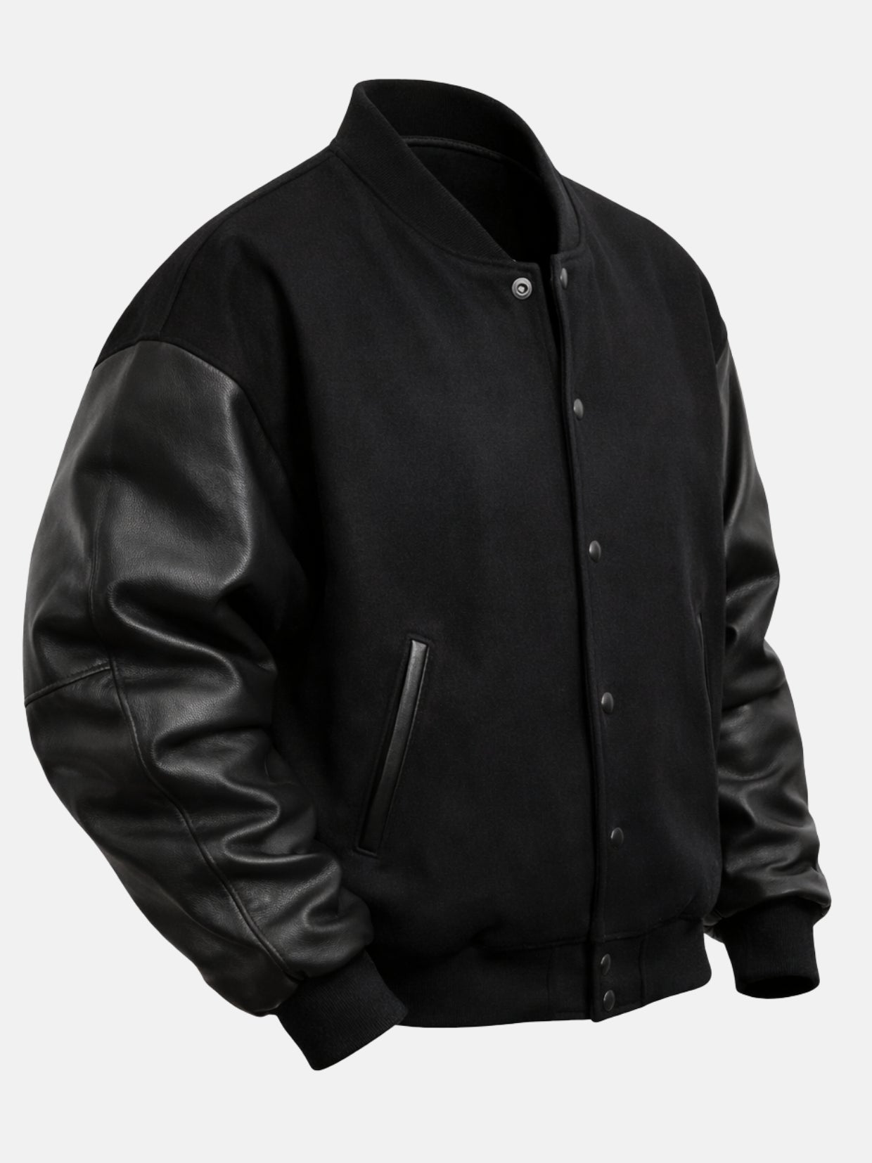 Angled front view of an all-black oversized varsity jacket with rib collar and snaps