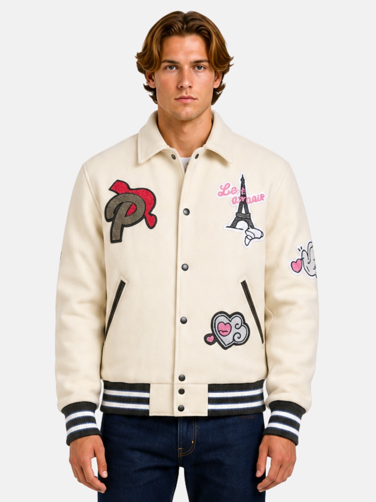 Man wearing a beige varsity jacket with embroidered Paris patches and shirt collar