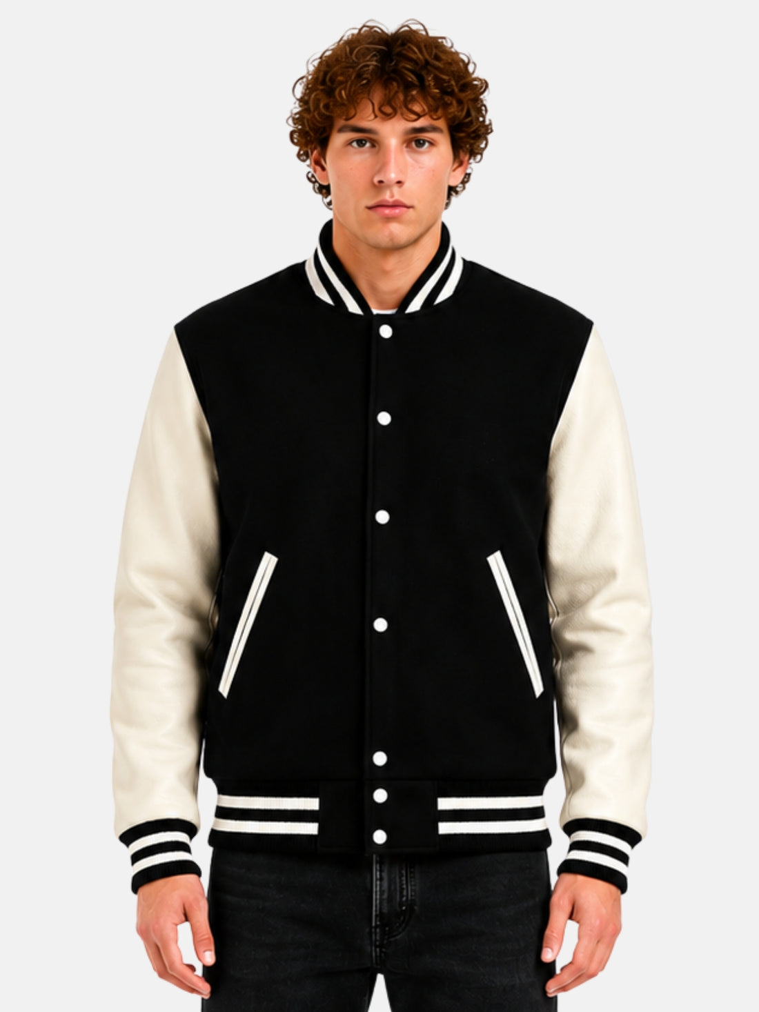 Man wearing a black and white varsity jacket with striped rib trims and white snaps