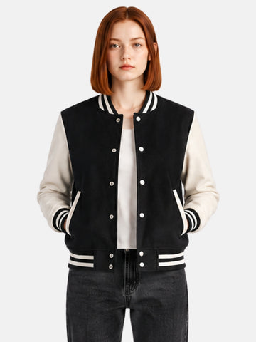Woman wearing a black and white varsity jacket with cream leather sleeves