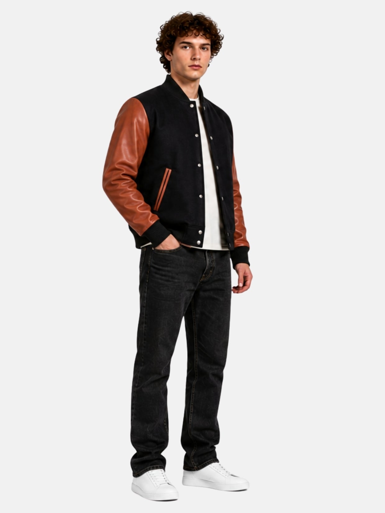 Full-length outfit with black and brown letterman jacket, dark jeans and white sneakers