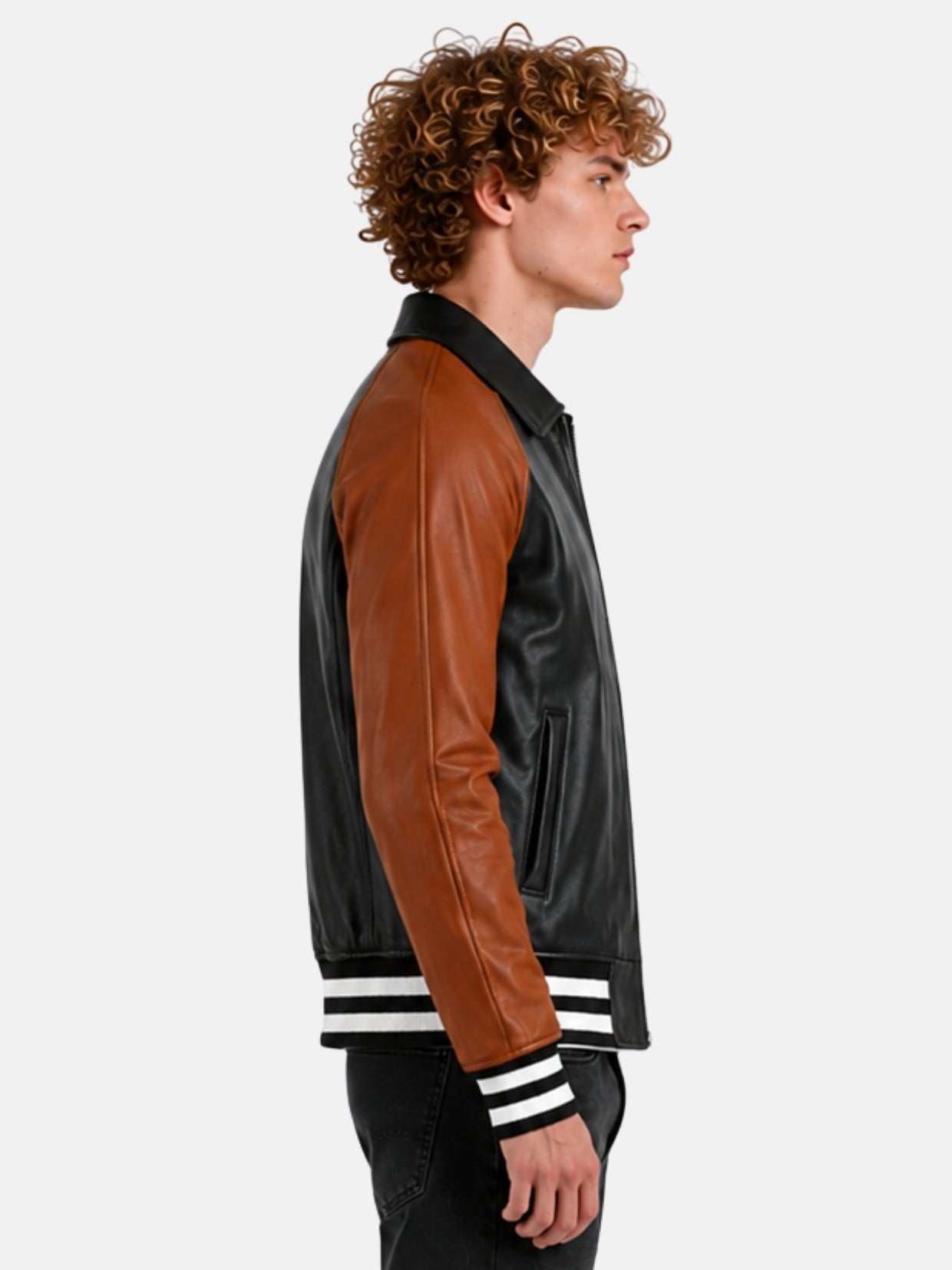 Side profile of black leather varsity jacket with saddle brown sleeve