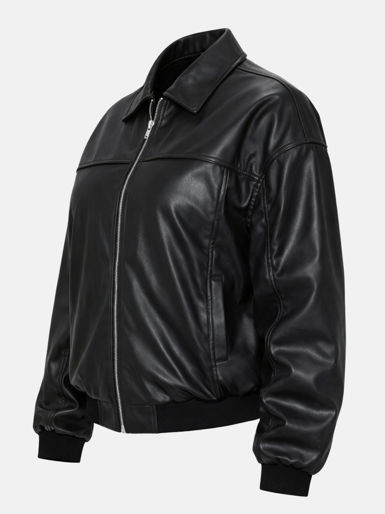 Angled flat lay of black leather bomber jacket showing yoke seam and pocket