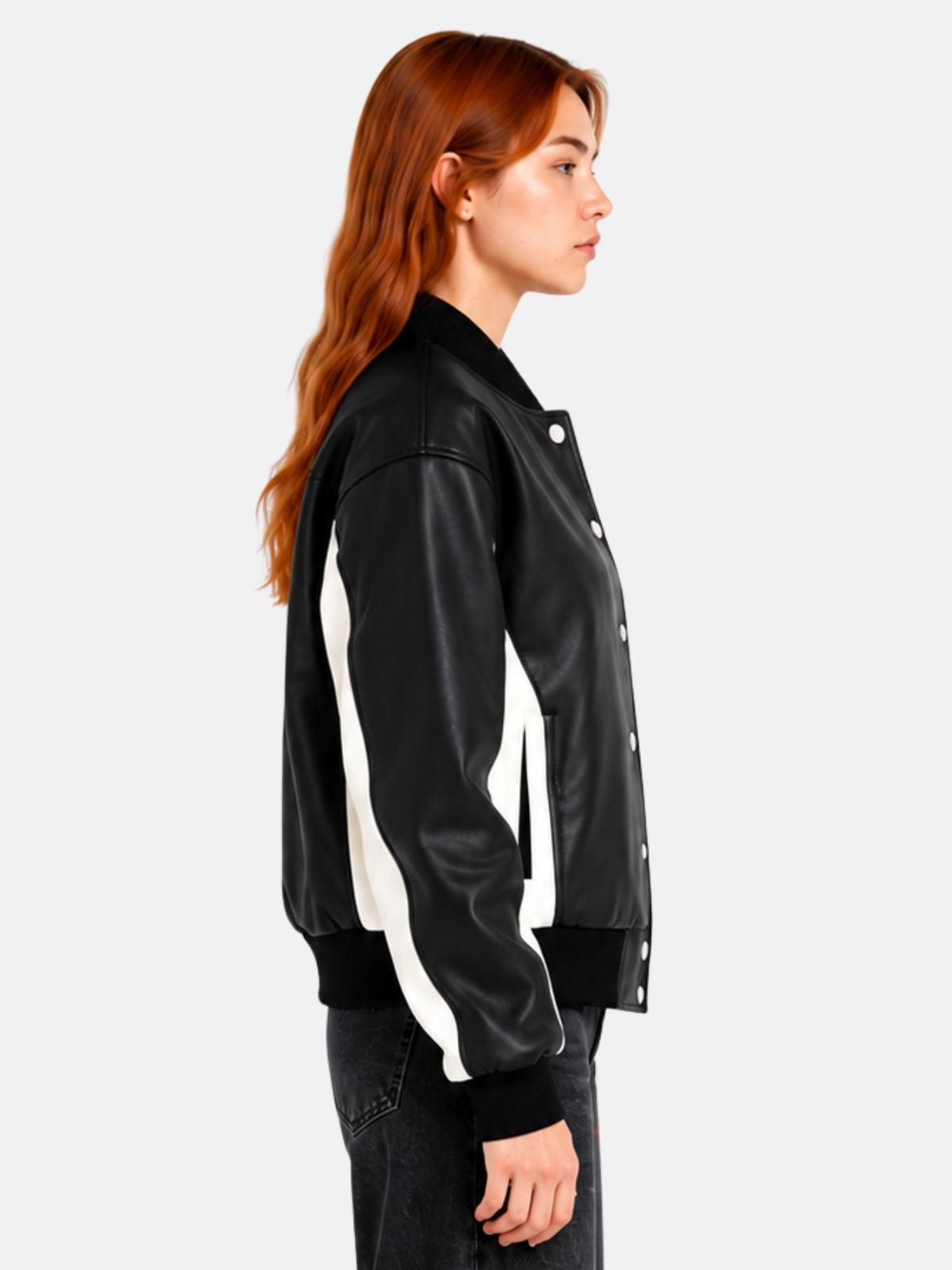 Side profile of black leather jacket showing the cream panel and welt pocket