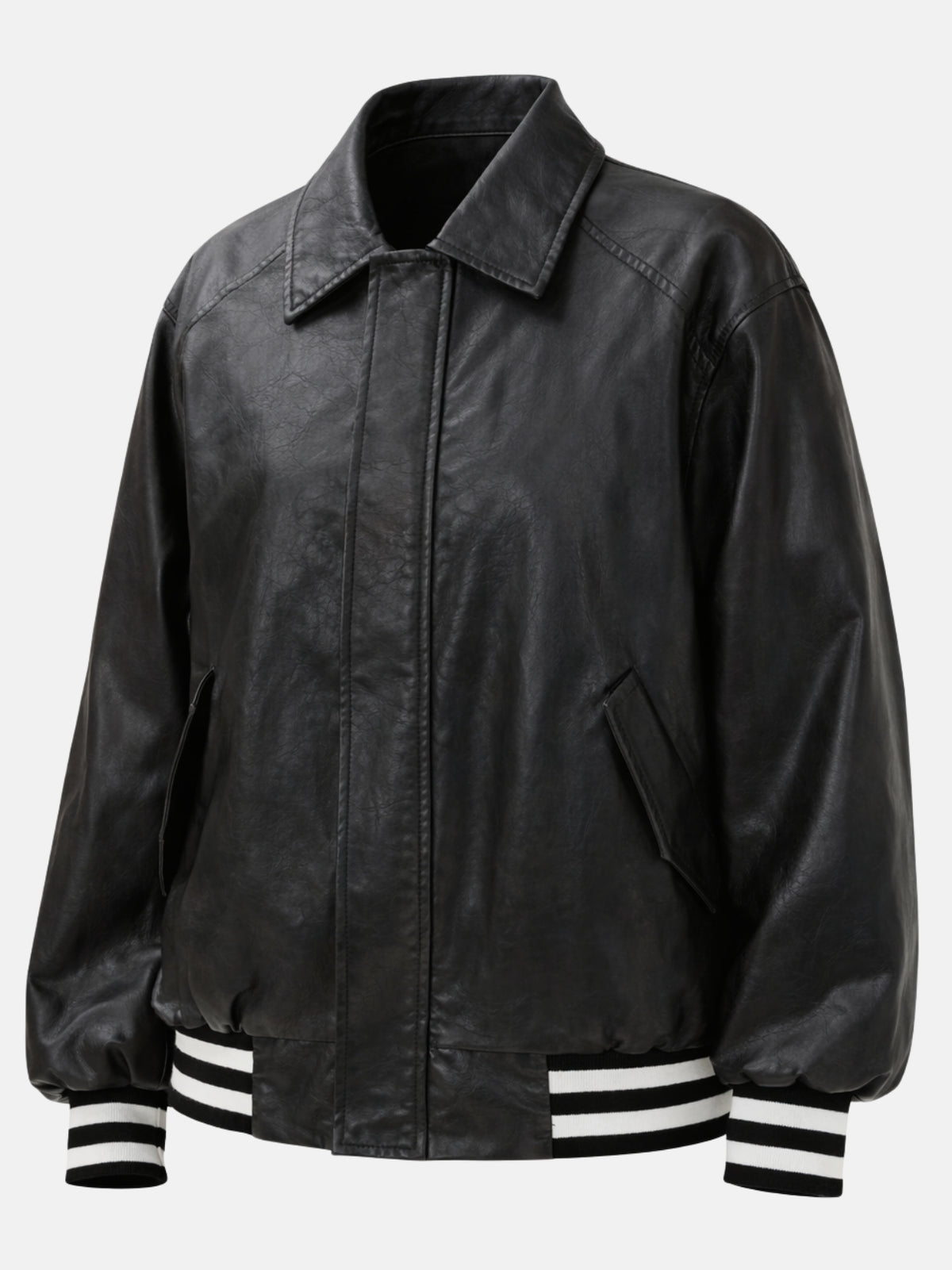 Angled flat lay of black leather jacket showing pointed collar and slanted pocket