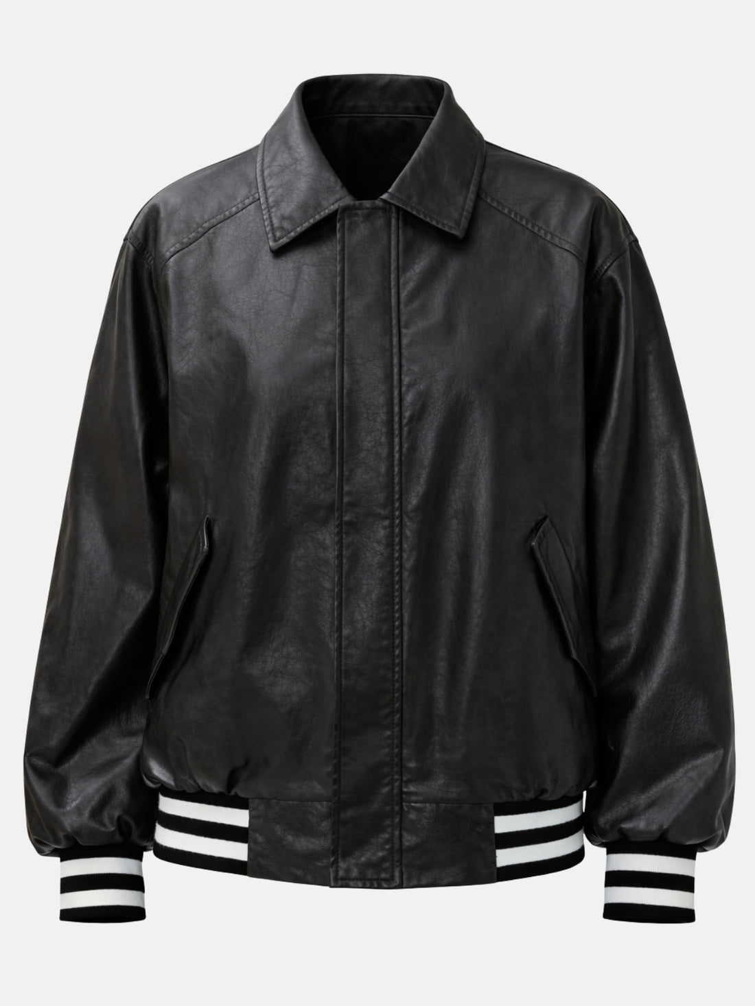 Oversized black leather jacket with pointed collar and concealed snap placket on model