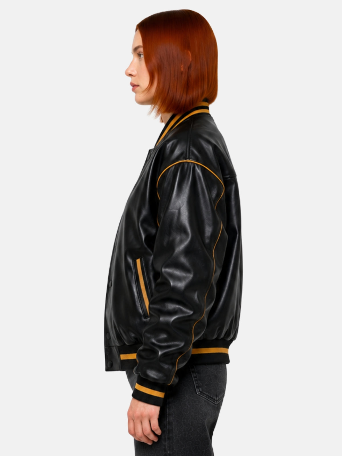 Side profile of black leather jacket showing gold piping along the sleeve seam