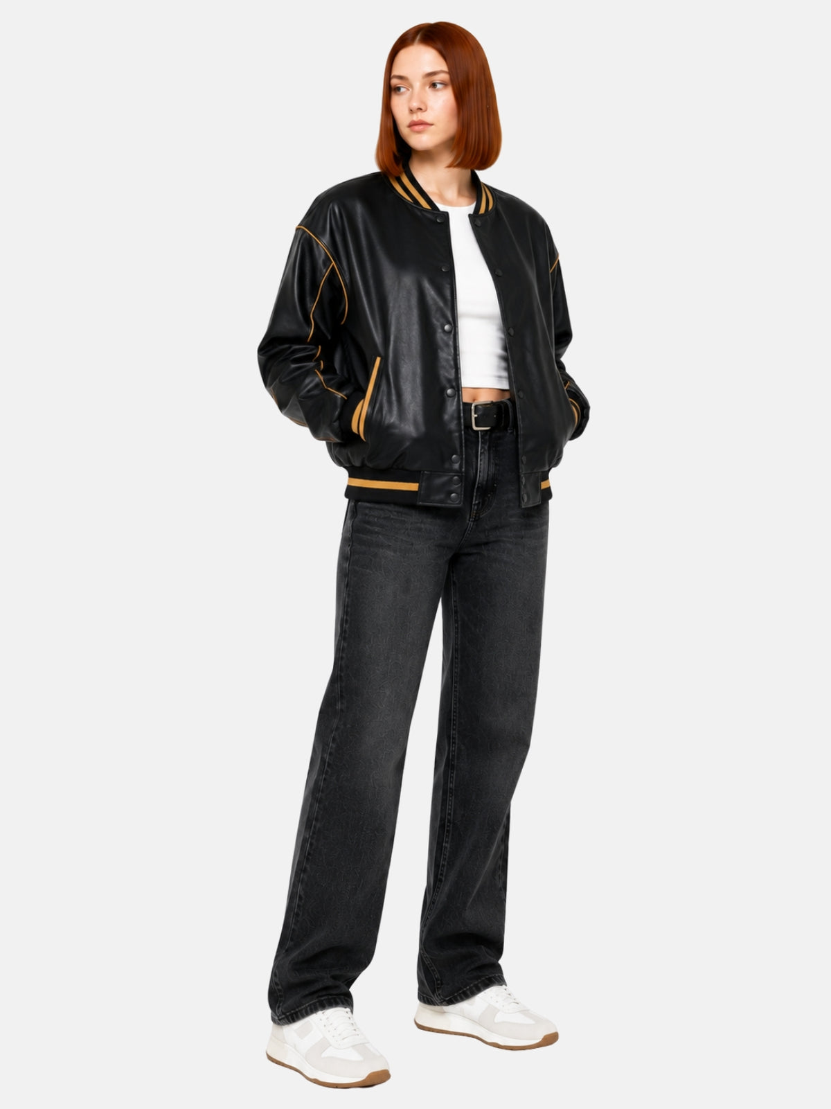 Full-length view of black leather jacket with gold piped seams over jeans