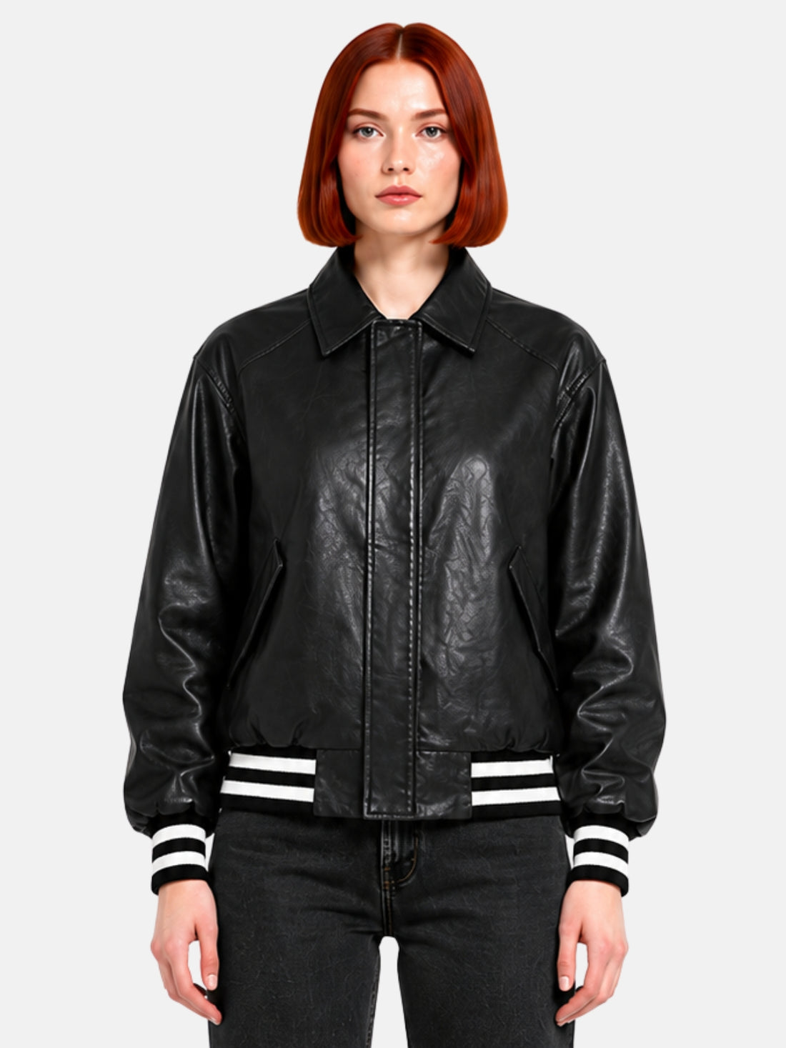 Oversized black leather jacket with pointed collar and concealed snap placket on model