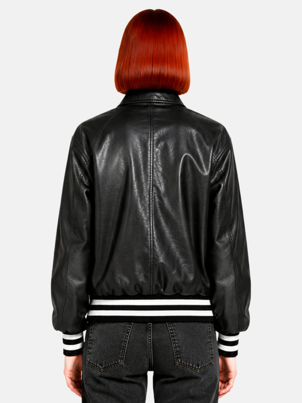 Back view of oversized black leather jacket showing raglan seams and pointed collar