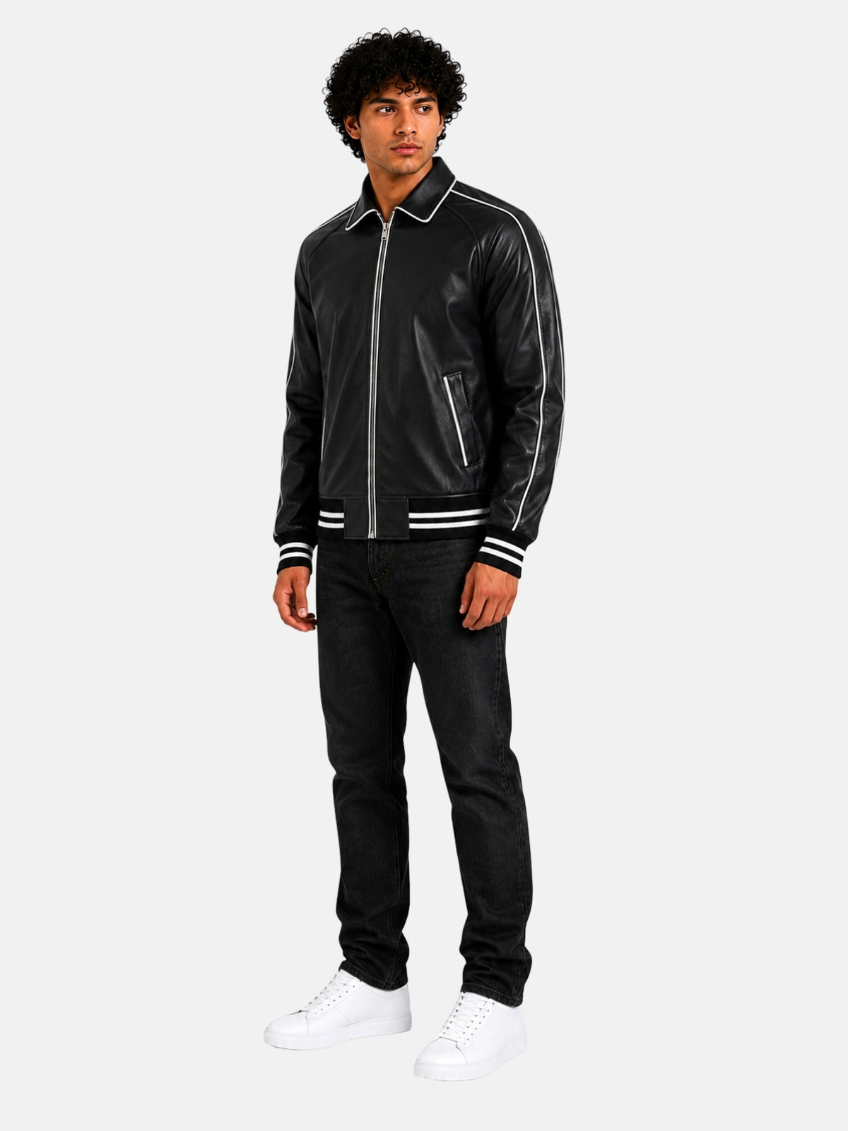 Full-length outfit with black leather letterman jacket, black jeans and white sneakers
