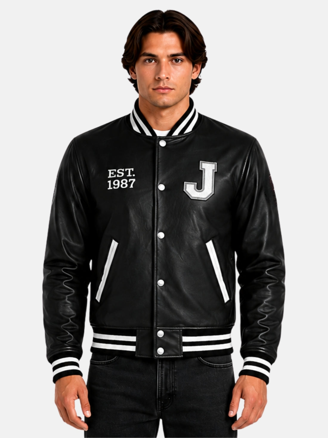 Man wearing black leather letterman jacket with white J patch and Est 1987 embroidery