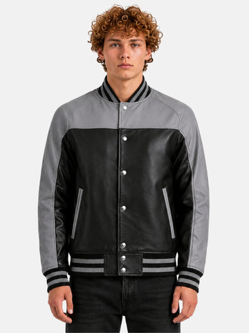 Man wearing black leather varsity jacket with grey raglan sleeves, grey yoke and striped rib trims