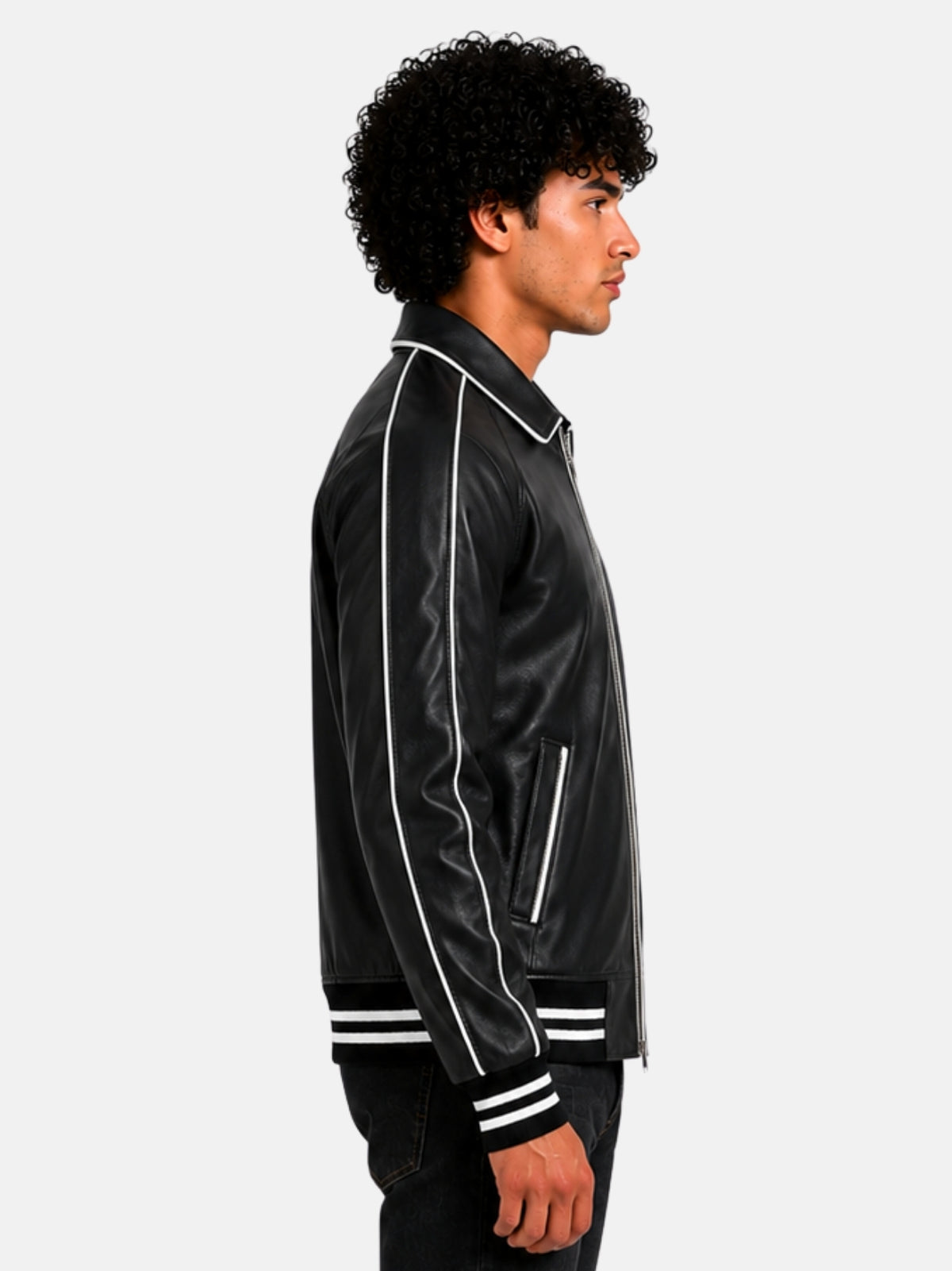 Side profile of black leather varsity jacket showing white piped raglan sleeve on model