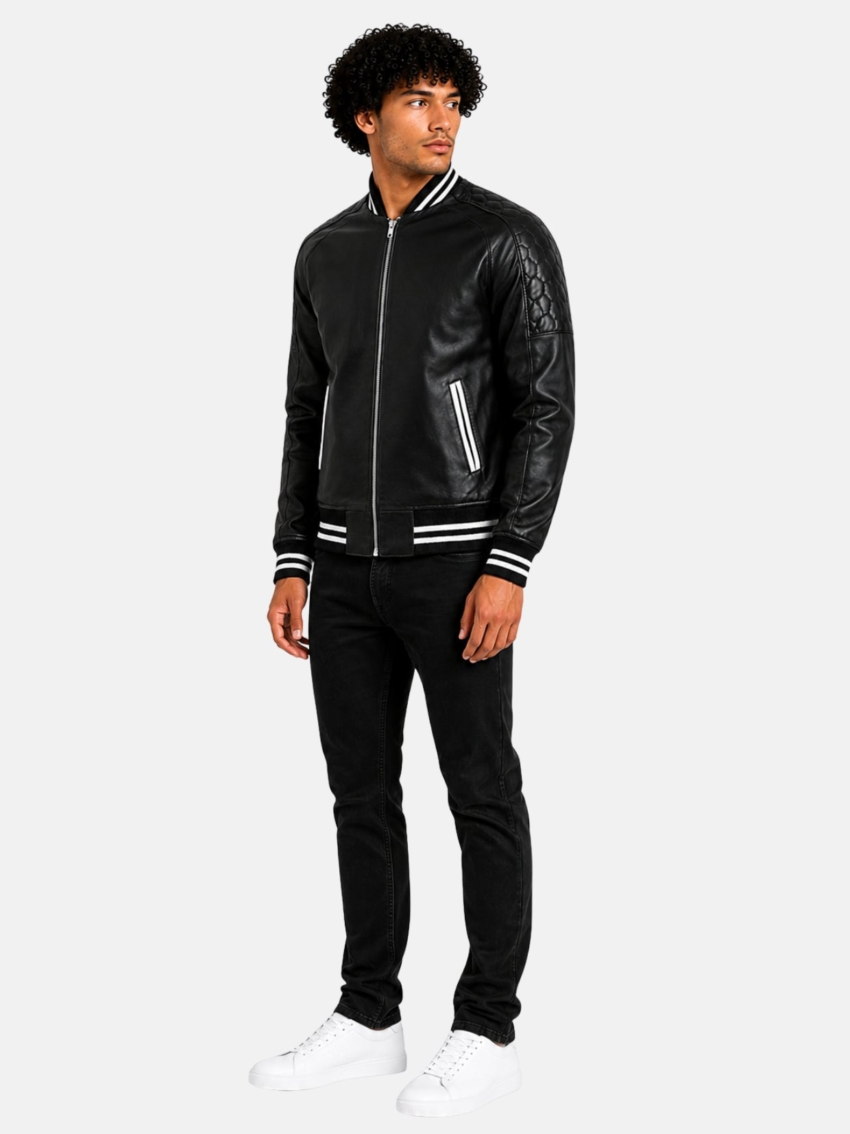 Full-length look with zip-up black leather varsity jacket, black jeans and white sneakers