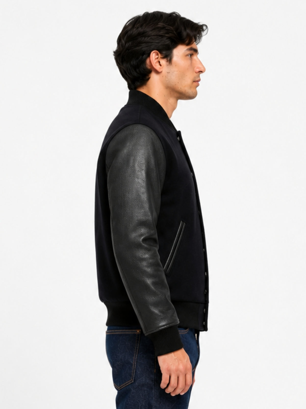 Side view of pebbled black leather sleeve and ribbed cuff on wool letterman jacket