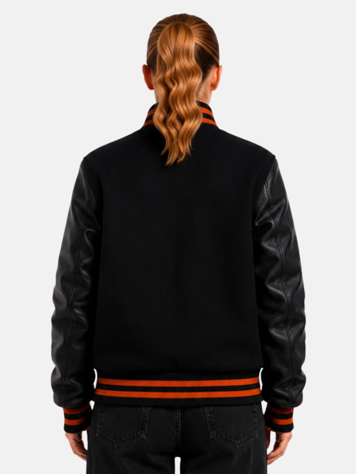 Back view of black varsity jacket with leather sleeves and orange collar