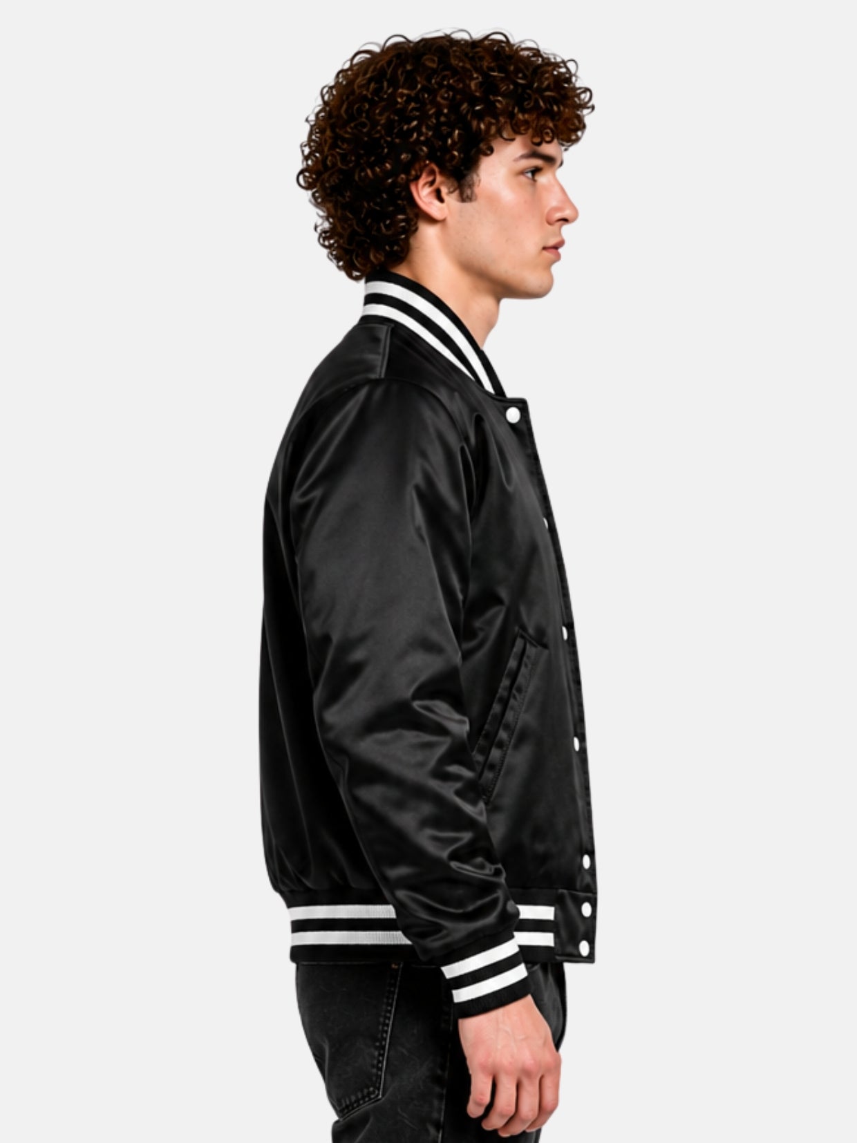 Side profile of a glossy black satin letterman jacket with striped collar on model