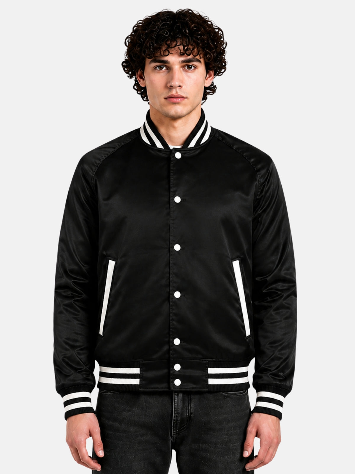 Man wearing a black satin varsity jacket with raglan sleeves and cream striped trims