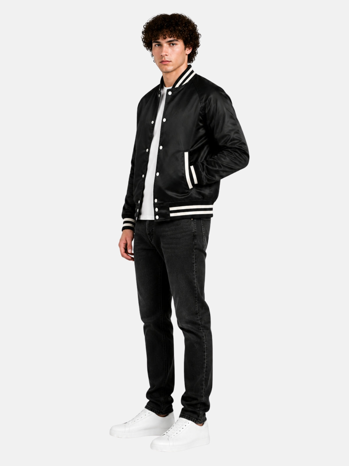 Angled full view of a black satin varsity jacket with cream stripe trims on model