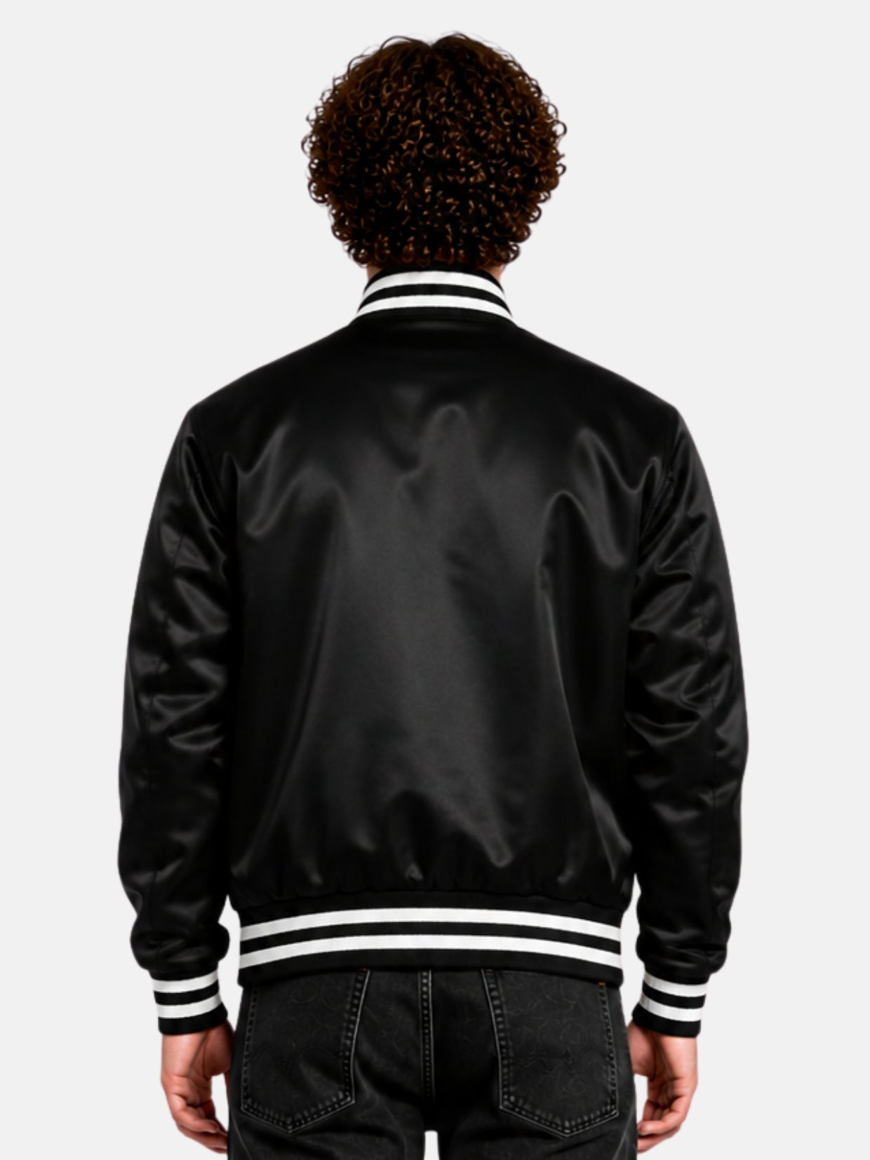 Back view of a black satin varsity jacket with striped rib collar and hem on model