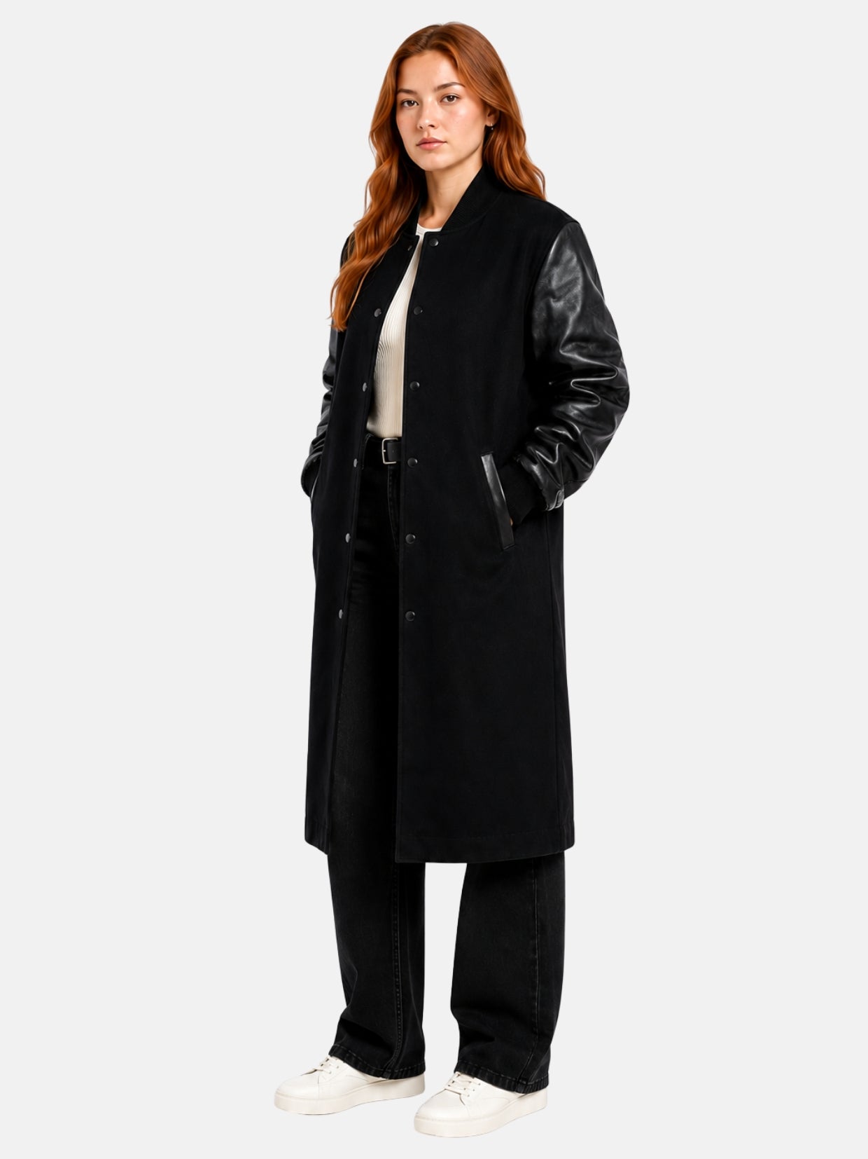 Full-length view of female model in black longline varsity coat with black denim