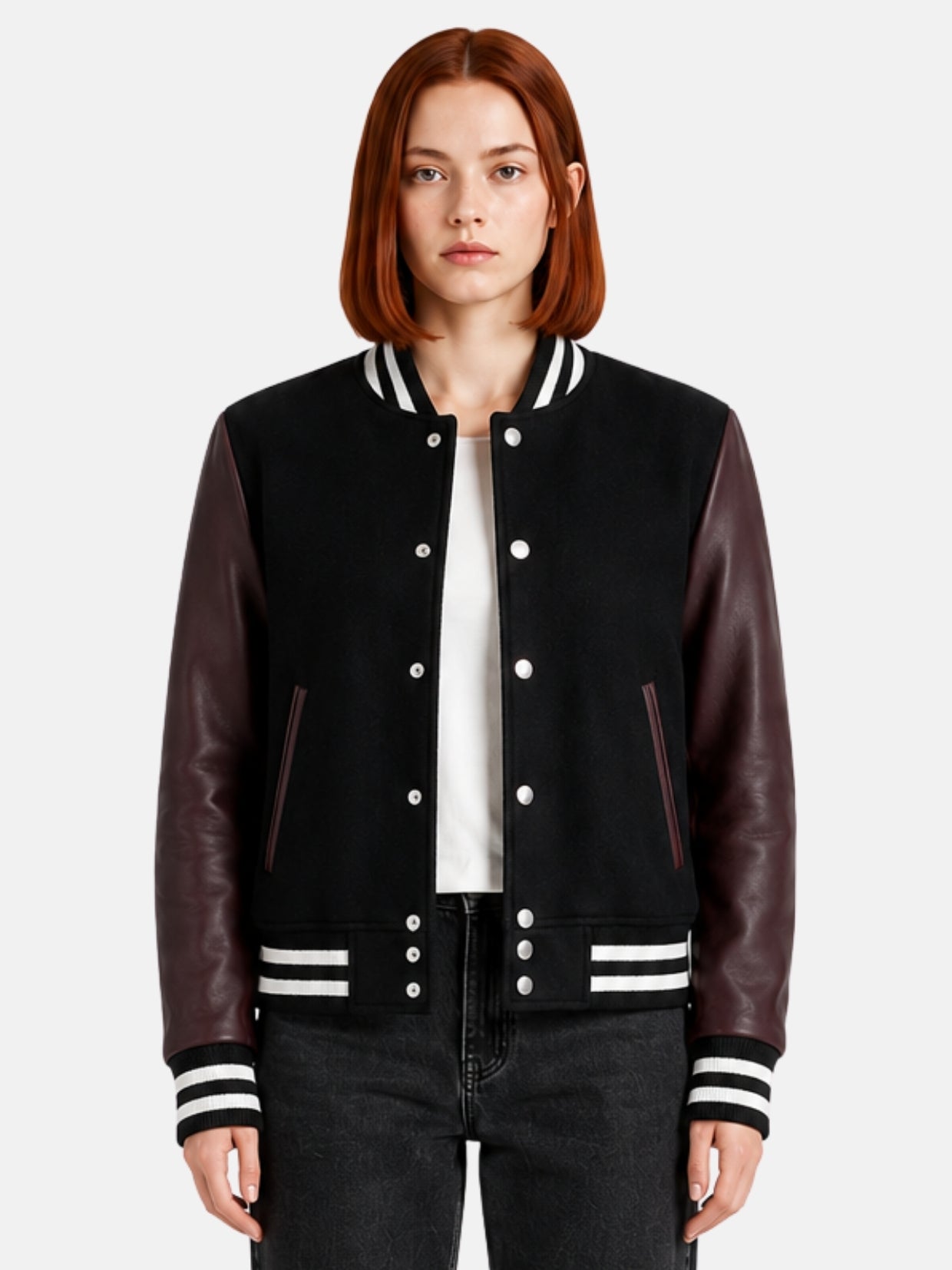 Woman wearing a black varsity jacket with burgundy leather sleeves and striped trims