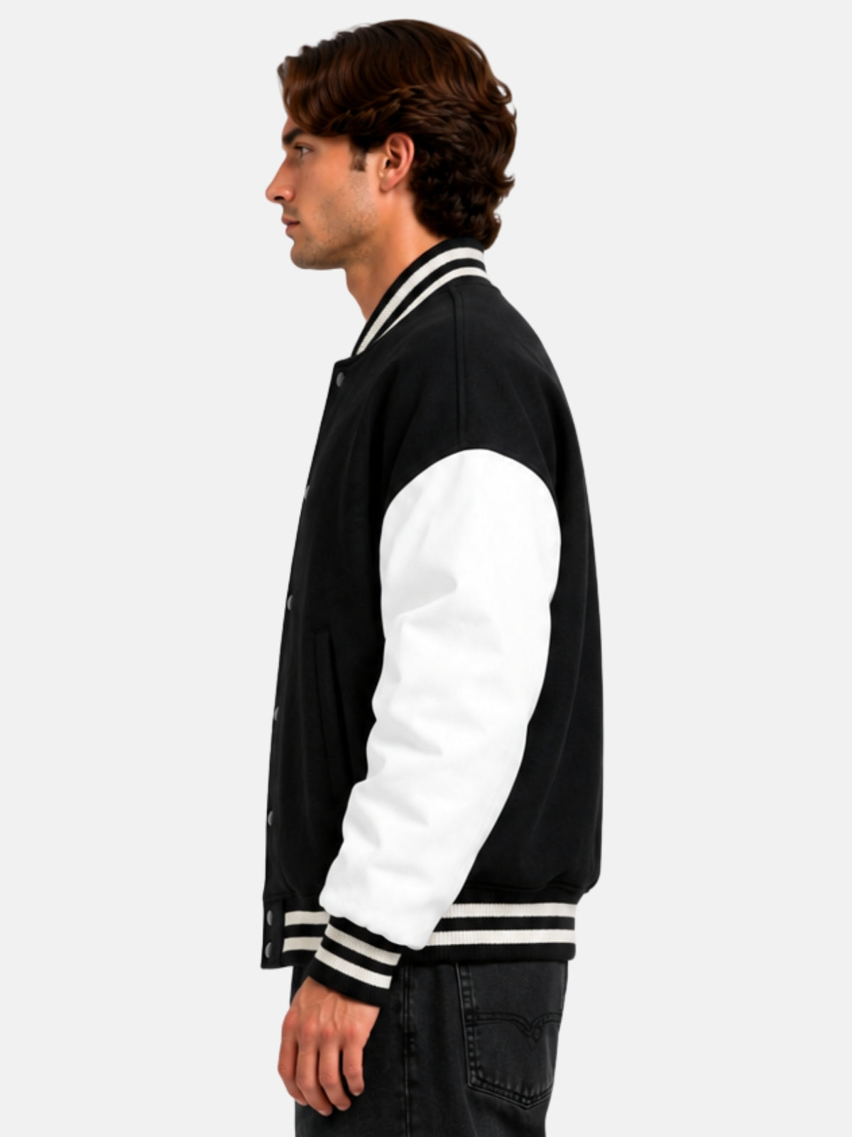 Side profile of oversized varsity jacket showing white leather sleeve and striped hem