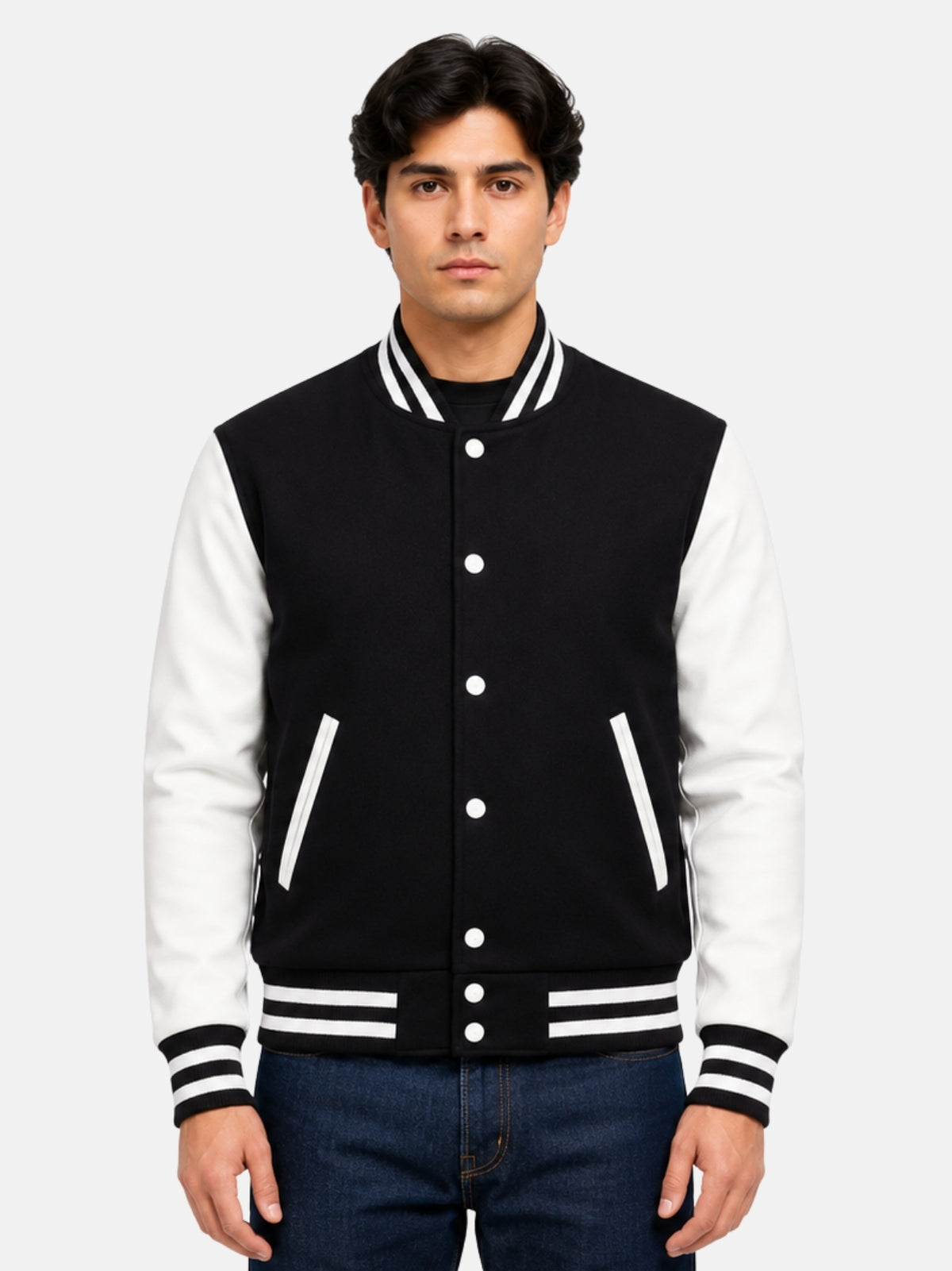 Man wearing black and white varsity jacket in size Medium with dark denim, front view