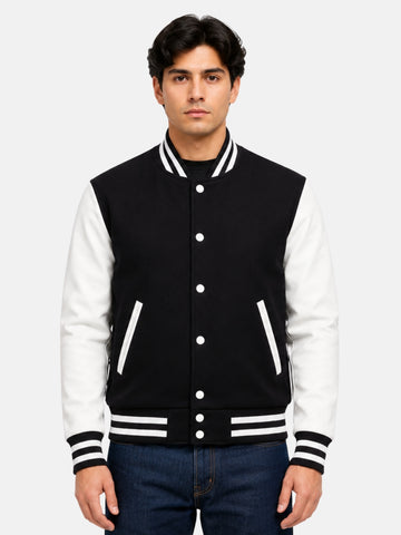 Man wearing black and white varsity jacket in size Medium with dark denim, front view