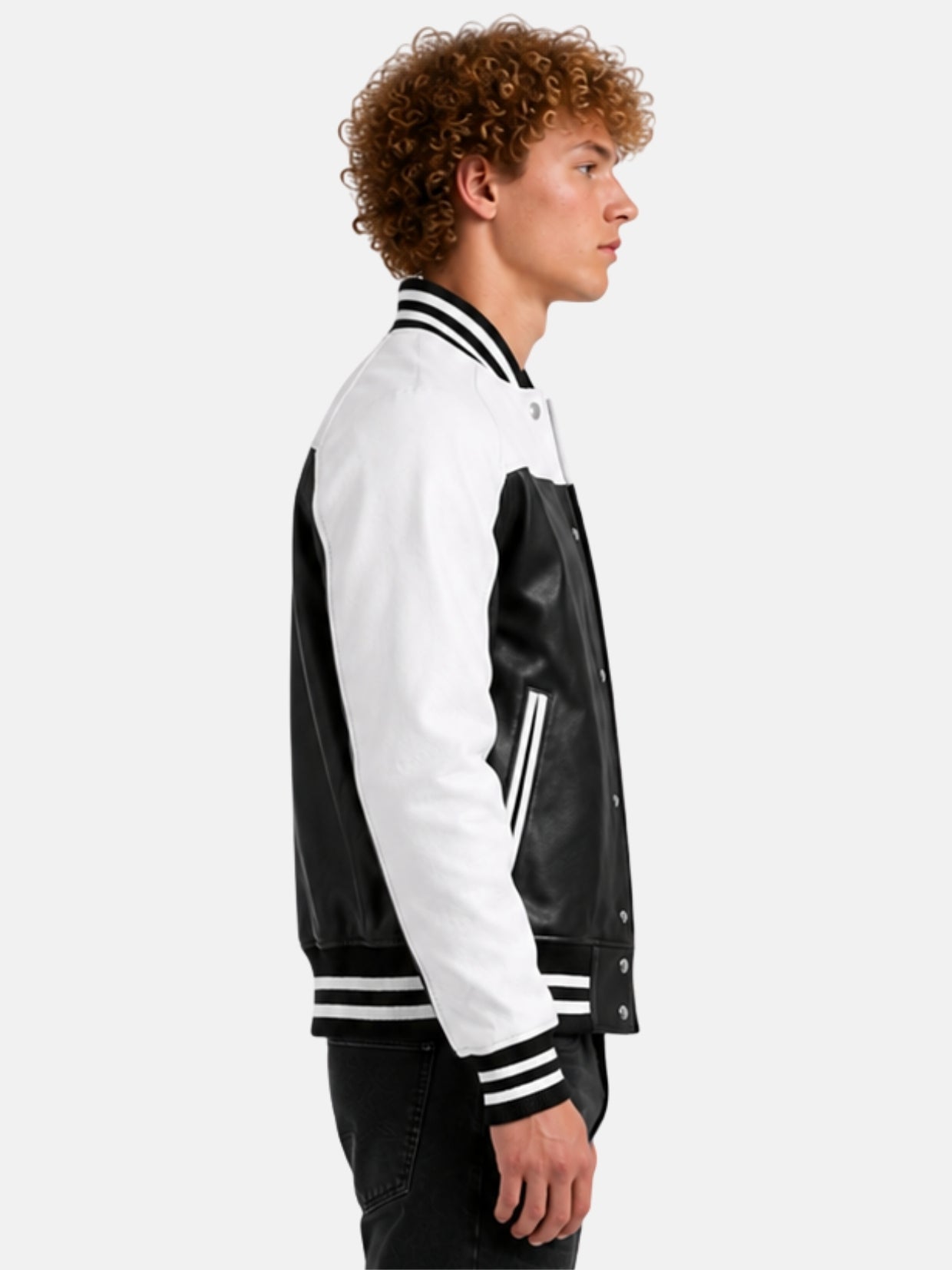 Side profile of black and white leather varsity jacket with white sleeve