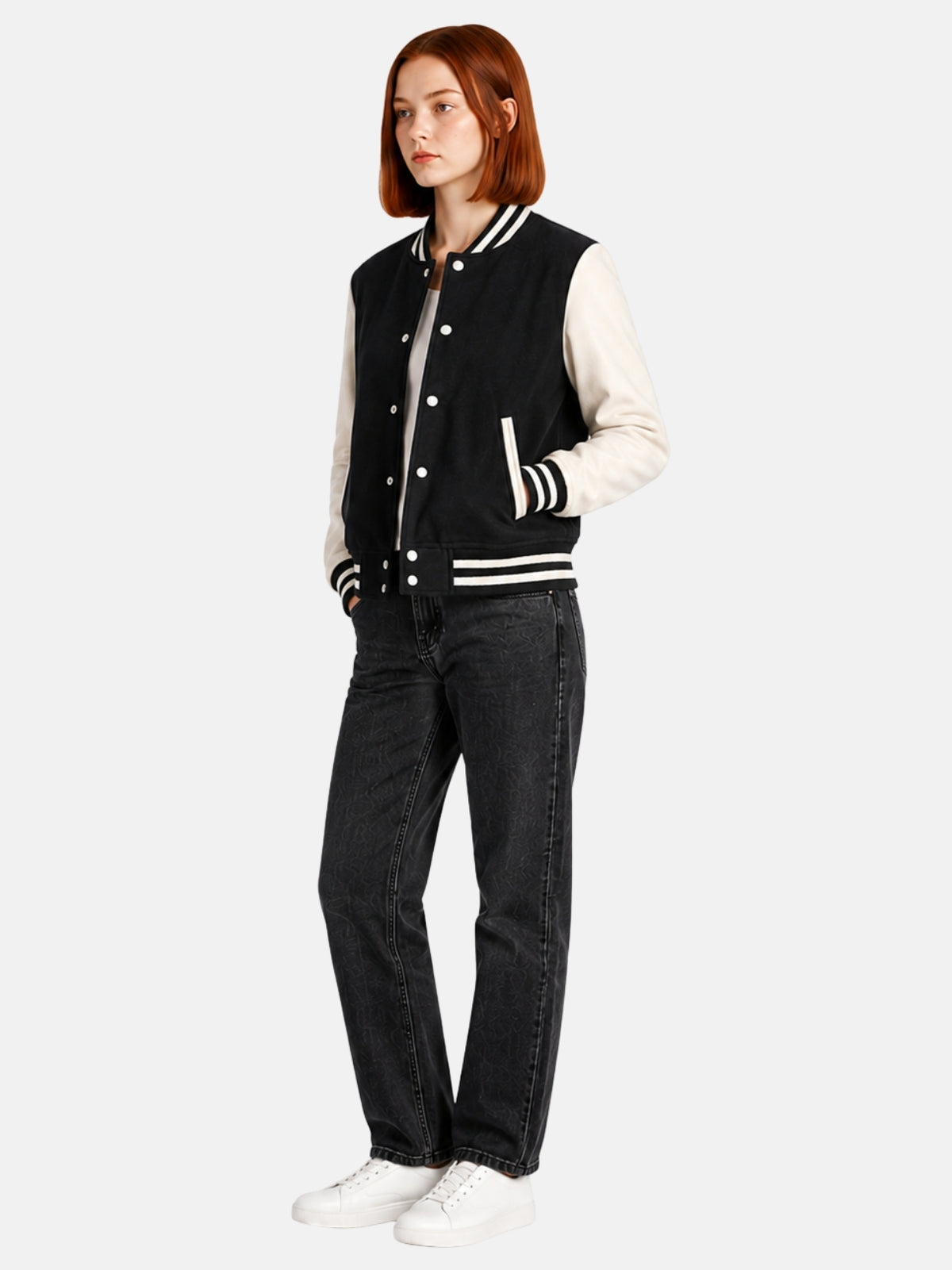 Full-length view of female model in black and white varsity jacket with dark jeans
