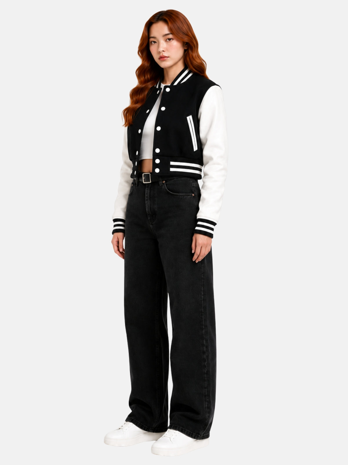 Full-body three-quarter shot of model in the black and white jacket, white sneakers and black wide-leg jeans
