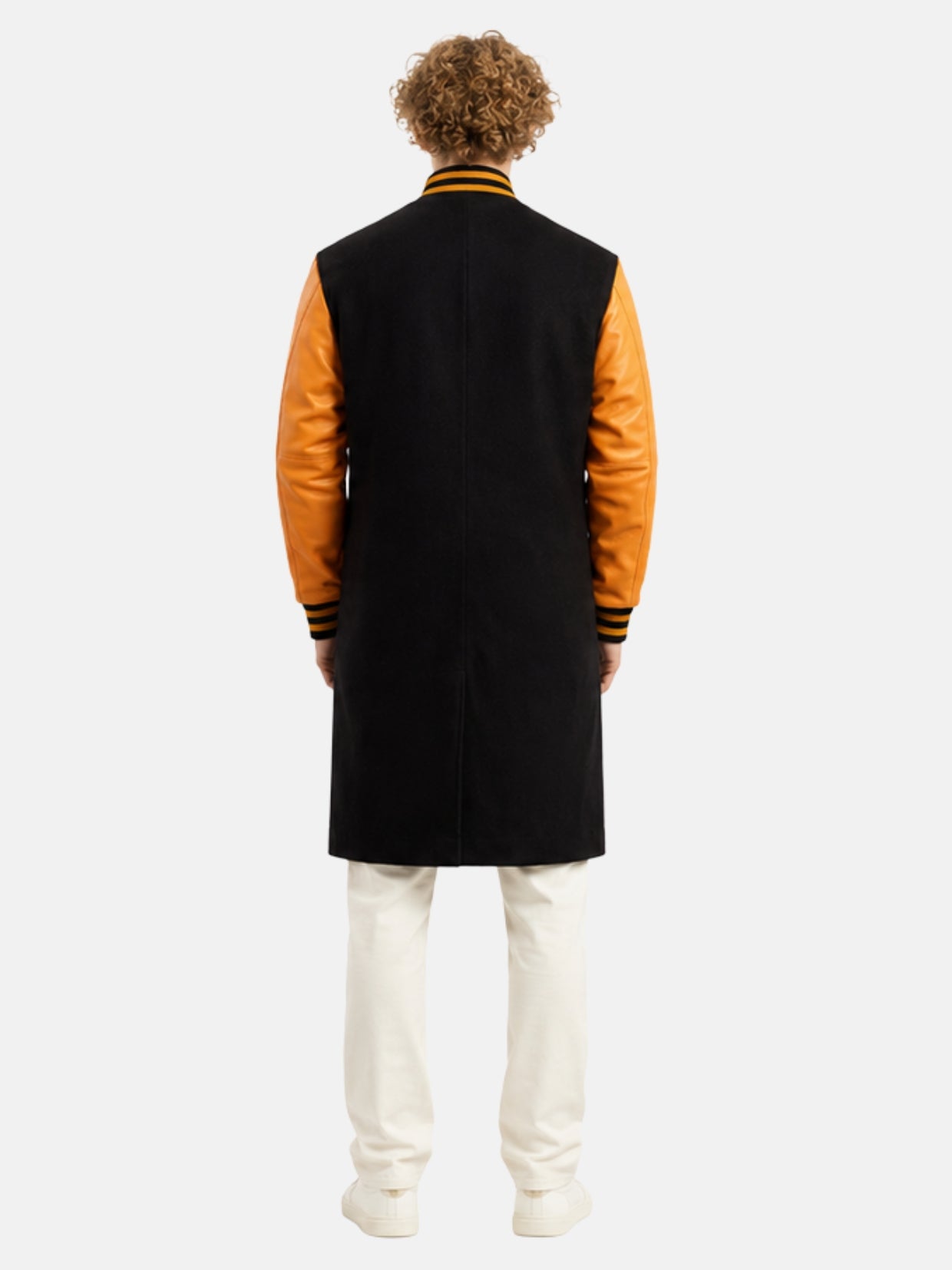 Back view of black wool varsity coat with orange leather sleeves on model