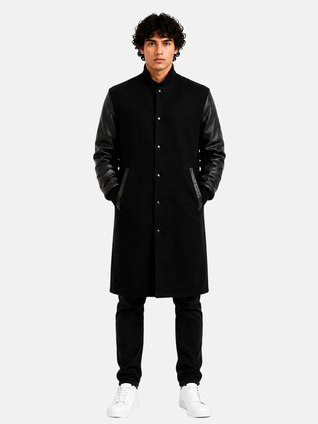 Man wearing knee-length black wool varsity coat with leather sleeves and snap front
