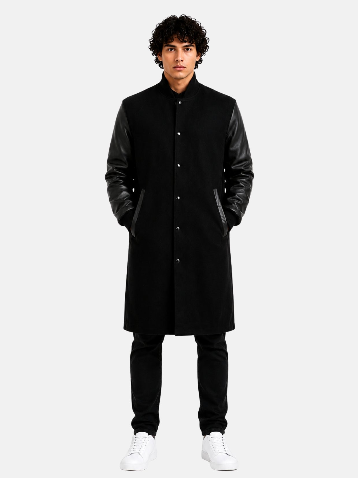 Man wearing knee-length black wool varsity coat with leather sleeves and snap front