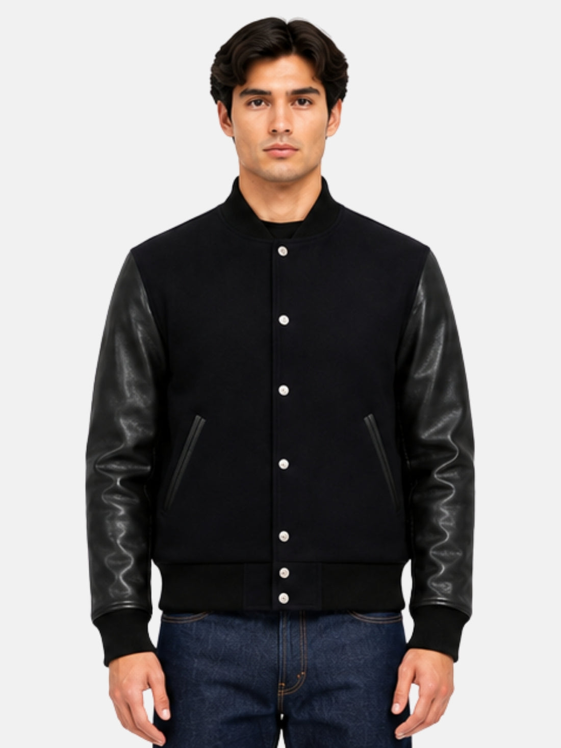 Man in all-black wool varsity jacket with leather sleeves and nickel snap front, size Medium