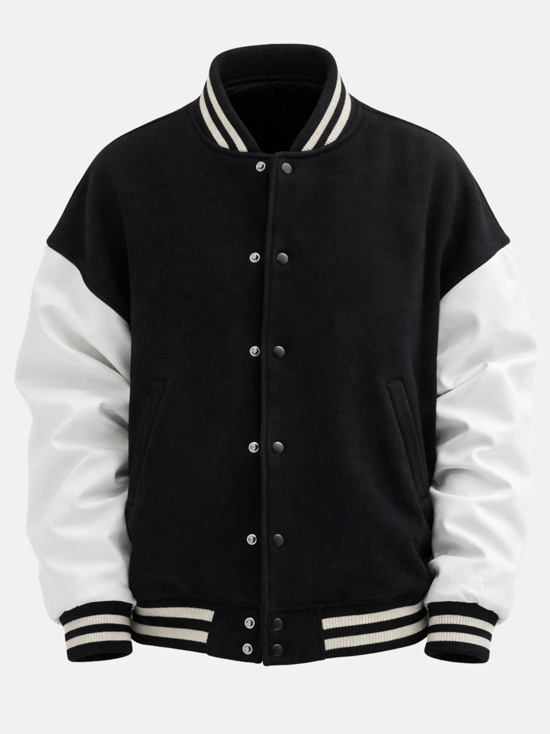 Man wearing oversized black varsity jacket with white leather sleeves and striped rib trims
