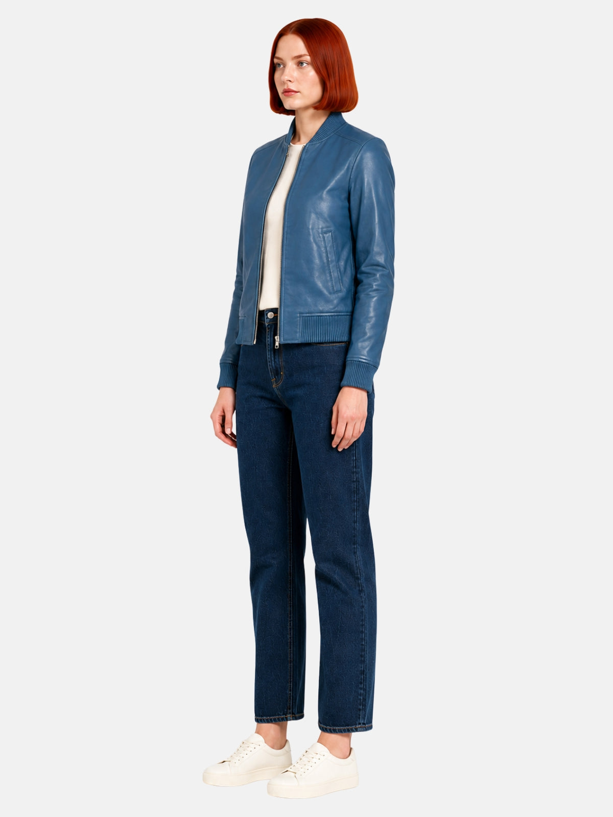 Full-length view of steel-blue leather bomber jacket over dark denim