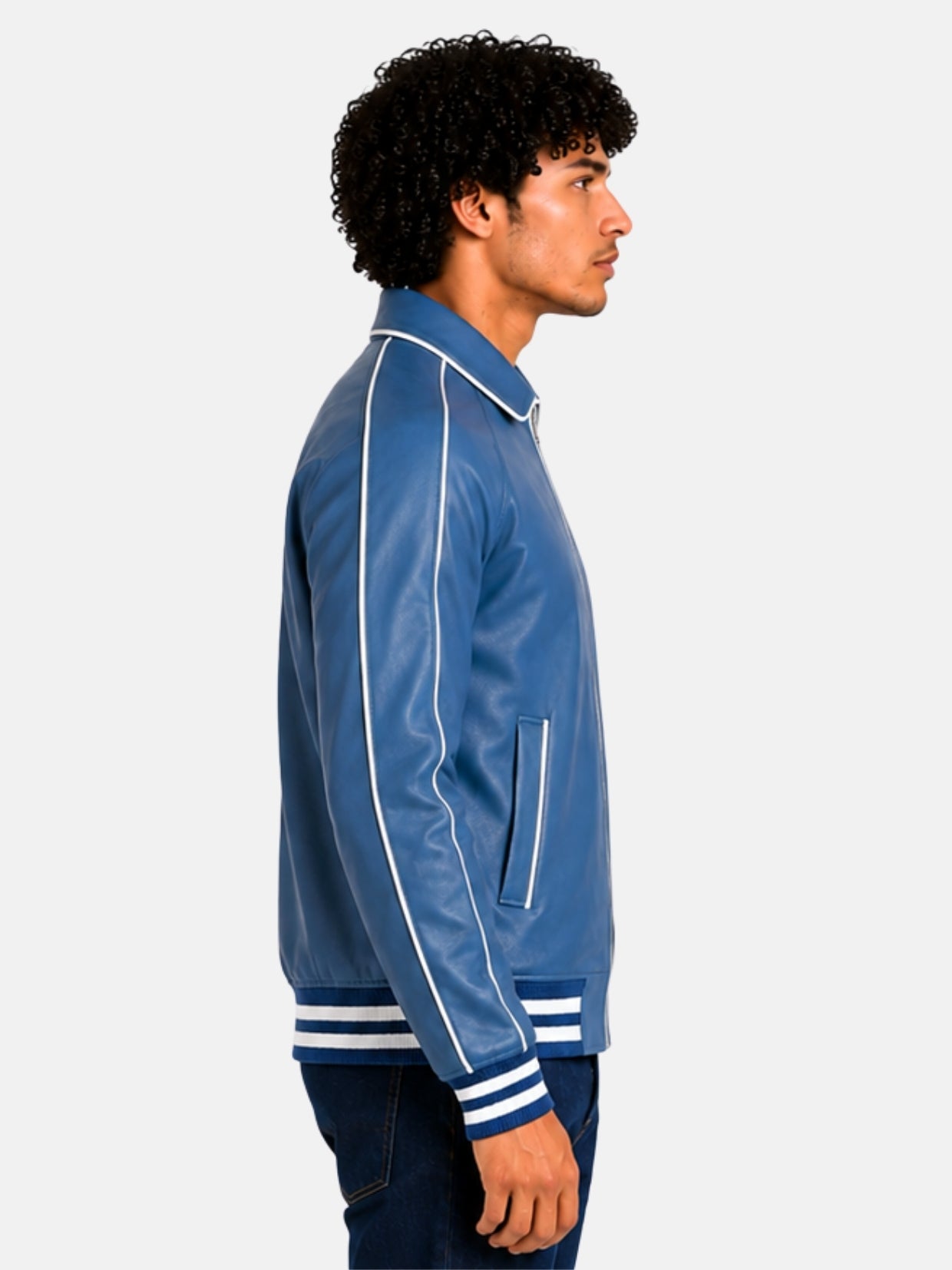 Side profile of blue leather varsity jacket with white piped raglan sleeve on model