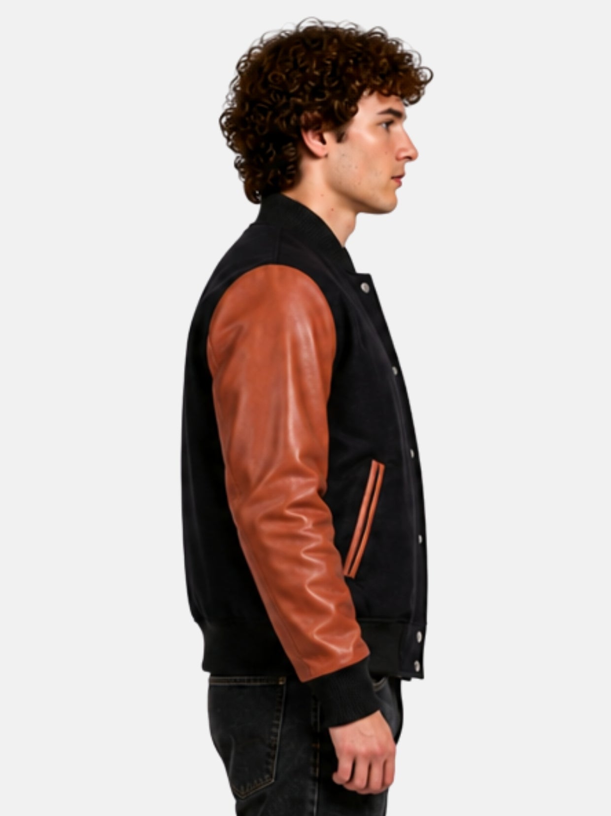 Side profile of black wool baseball-collar jacket with cognac leather sleeve on model