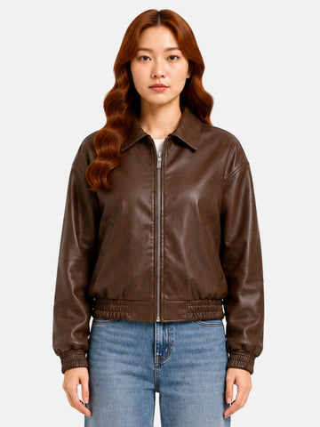 Brown leather jacket with pointed collar and cinched elastic waist on model