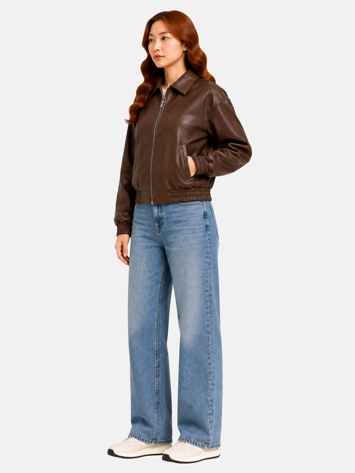 Full-length view of oversized brown leather jacket with balloon sleeves over jeans