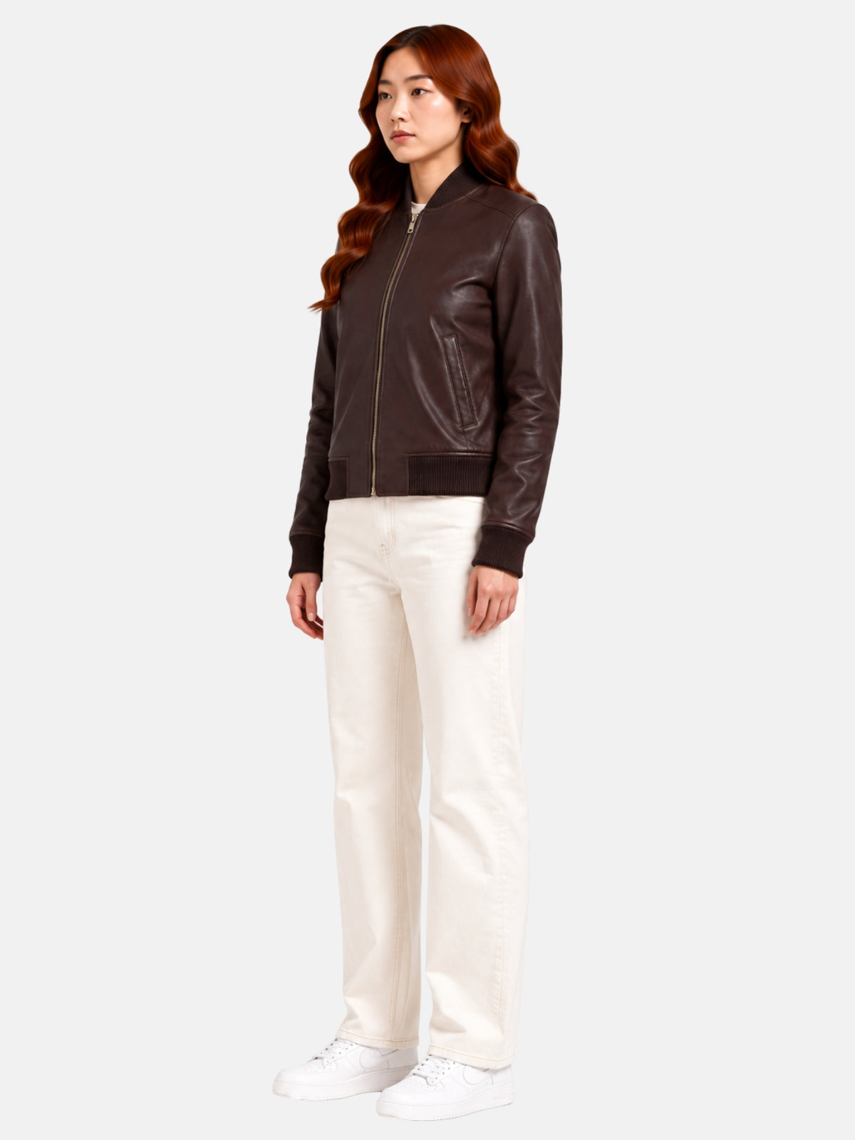 Full-length view of brown leather bomber jacket paired with cream wide-leg jeans