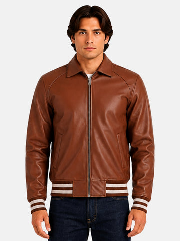 Man wearing brown leather varsity jacket with fold-down collar and silver zip