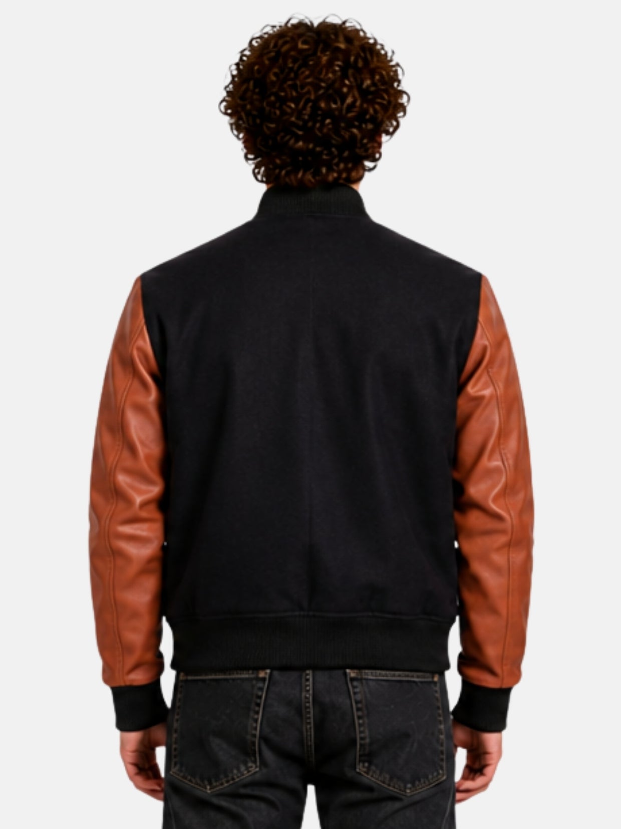 Model showing plain black back panel of varsity jacket with brown leather sleeves