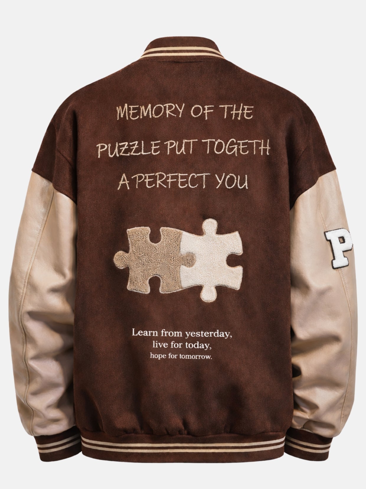 Flat back shot of a brown varsity jacket with large puzzle patch and embroidered mottos