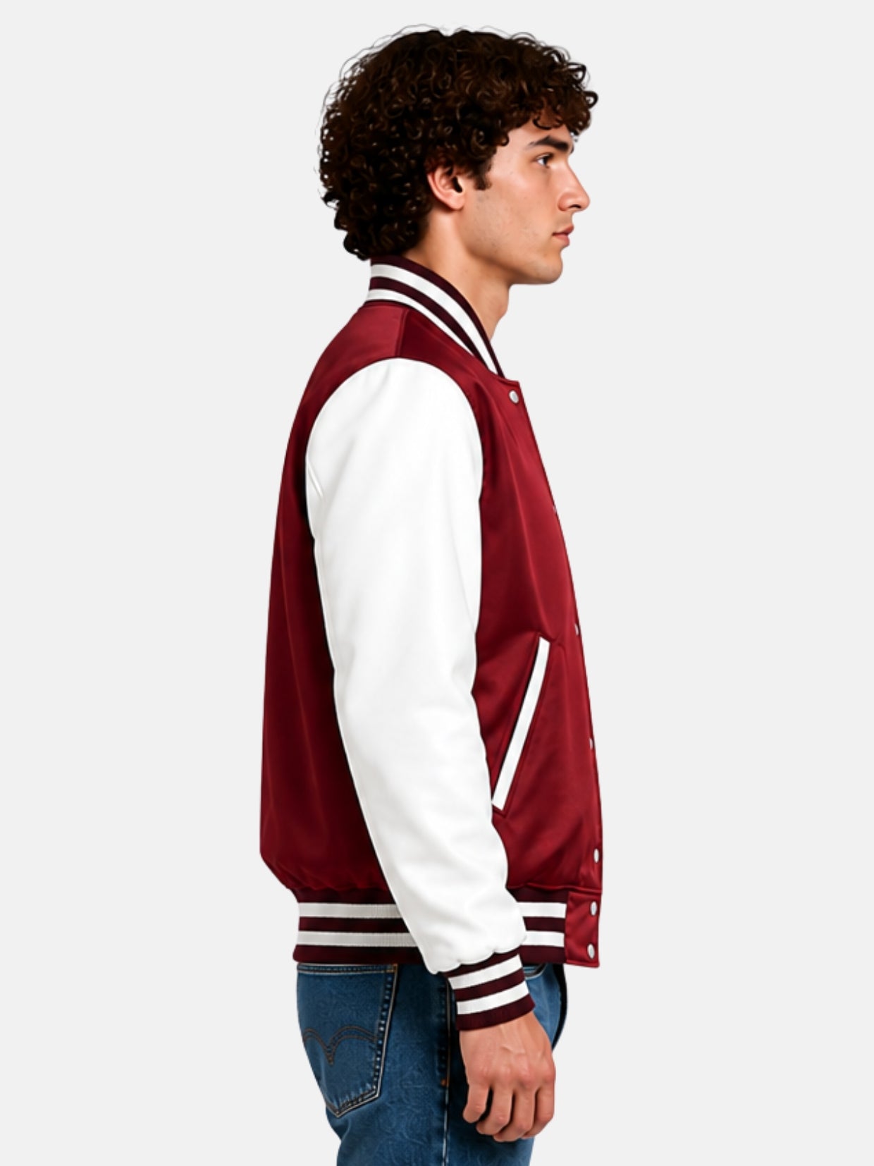Side profile of a burgundy satin letterman jacket with white sleeves on model