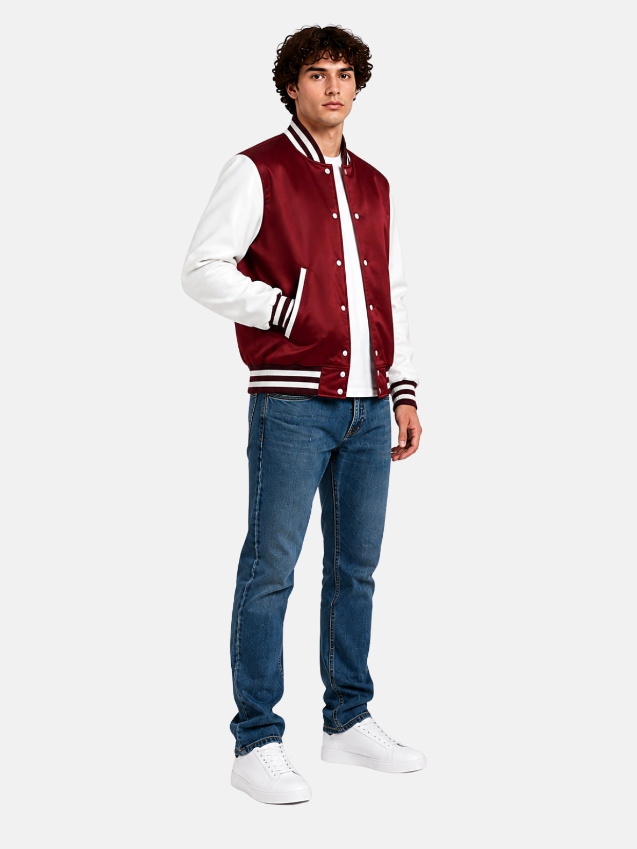 Full-length view of a burgundy satin varsity jacket with blue jeans and white sneakers