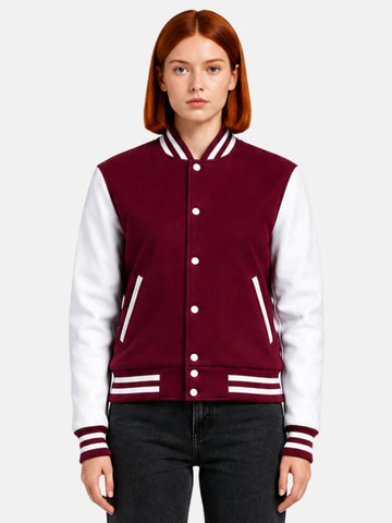 Woman wearing a burgundy varsity jacket with white leather sleeves and striped rib trims